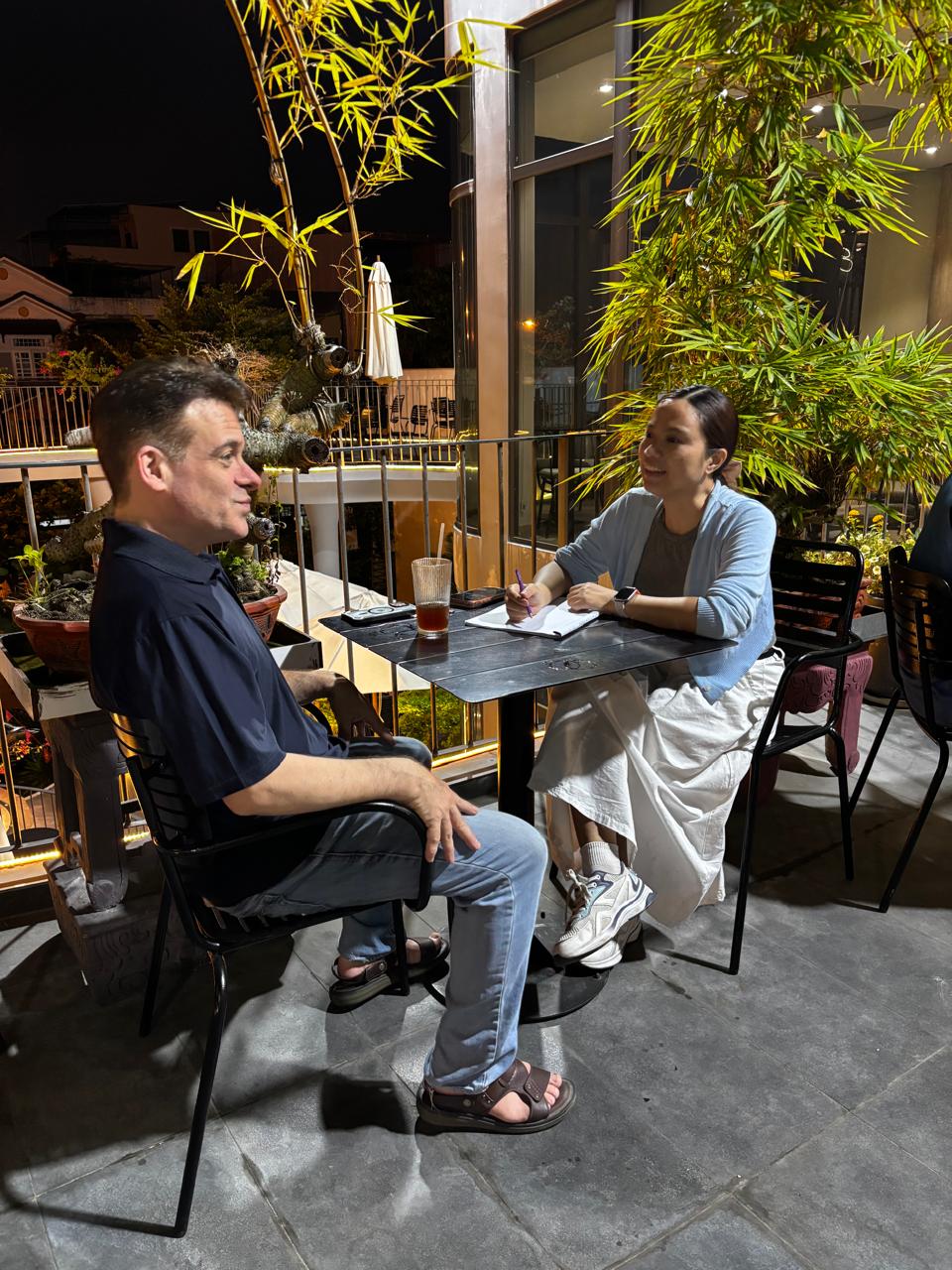 A relaxed outdoor table conversation at Heaven Coffee during the Friday, May 1, 2026 meetup.